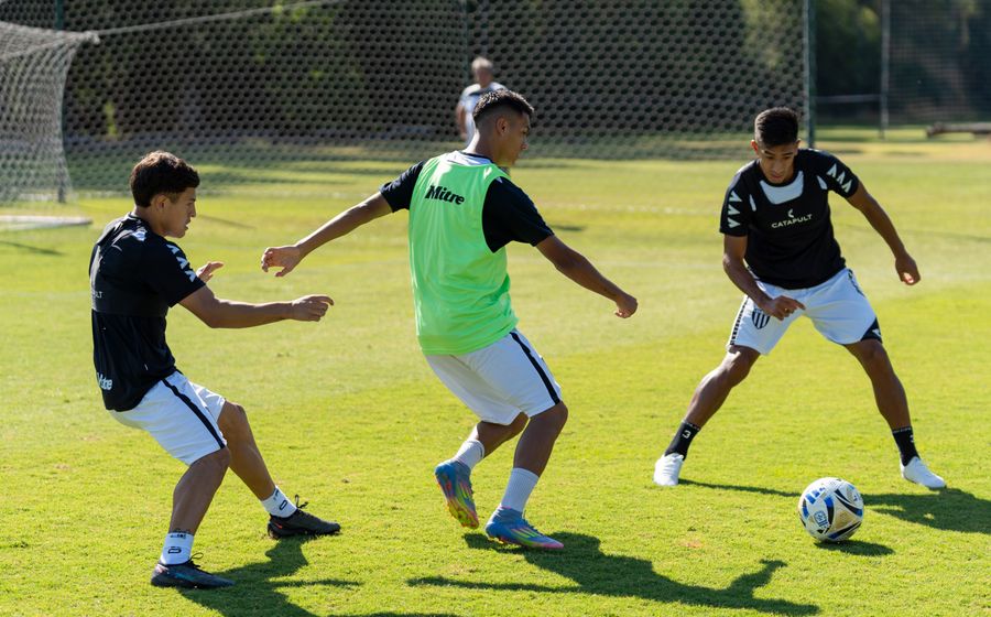 Small group of players competing for the ball in training